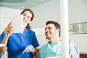 Smiling dentists looking at paperwork