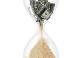 Money turning into sand in hourglass