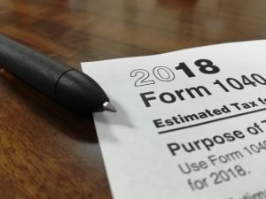 a tax form with a pen