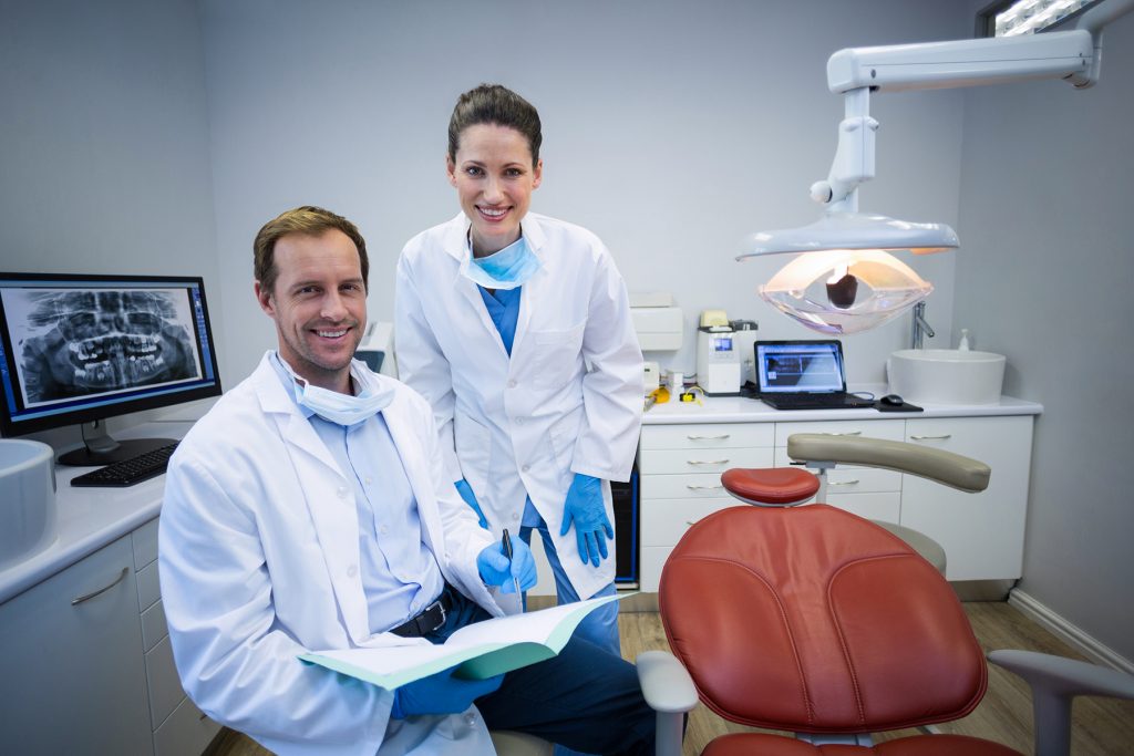 Two practicing dentists in an exam room