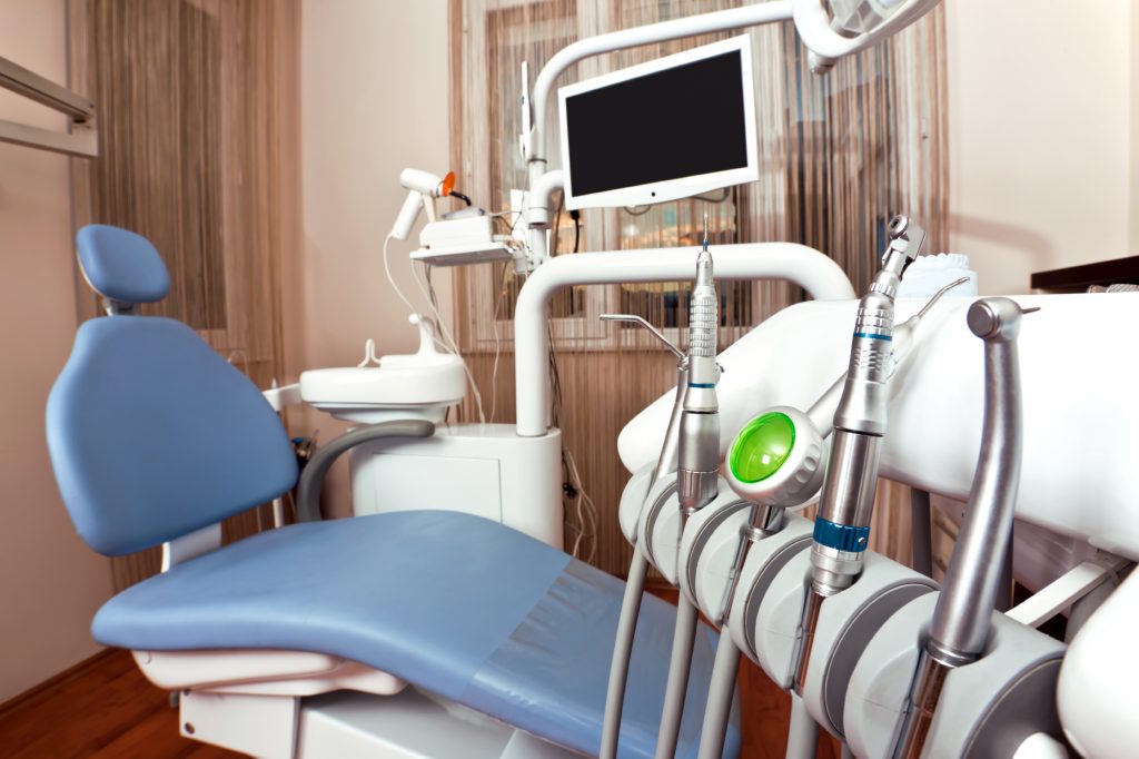 Empty exam room filled with dental equipment