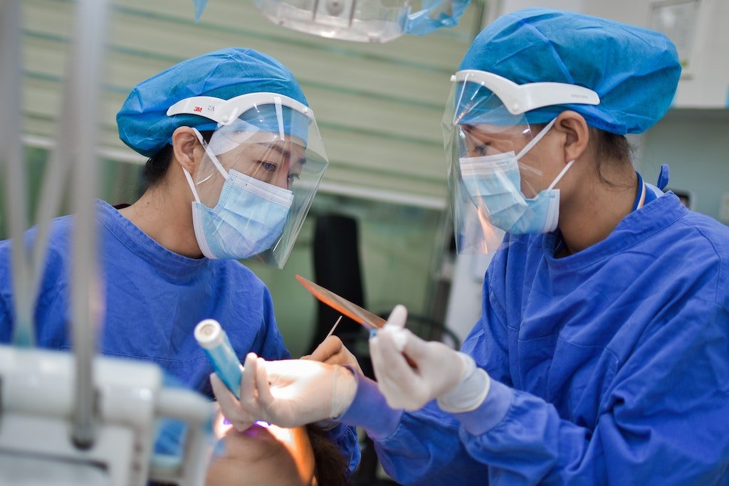 Two dentists conversing in PPE