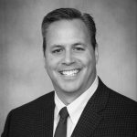 A black and white headshot of Peter Arsenault, DMD, MS MBA